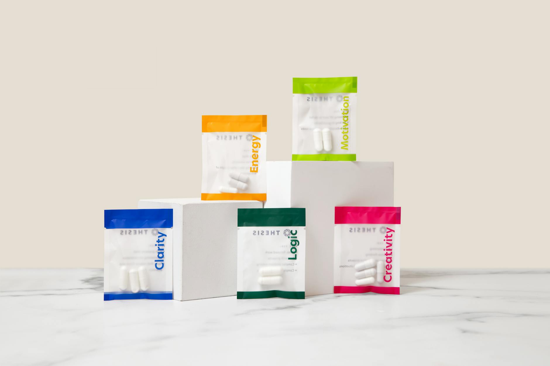 Vibrant display of nootropic supplements showcasing energy, motivation, creativity, and clarity on white blocks. — Atrium Scientific Group