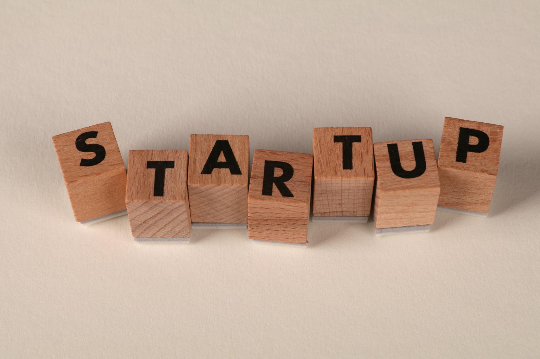Wooden blocks forming the word 'STARTUP' on a neutral background, symbolizing new business ventures. — Atrium Scientific Group