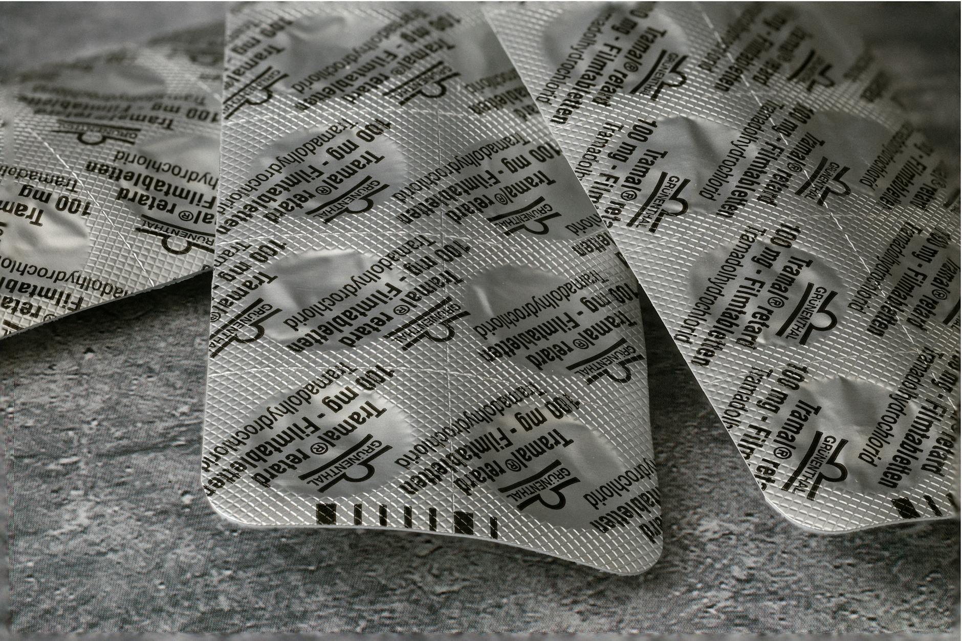 Close-up of Tramadol 100 mg blister pack on a textured concrete surface. — Atrium Scientific Group