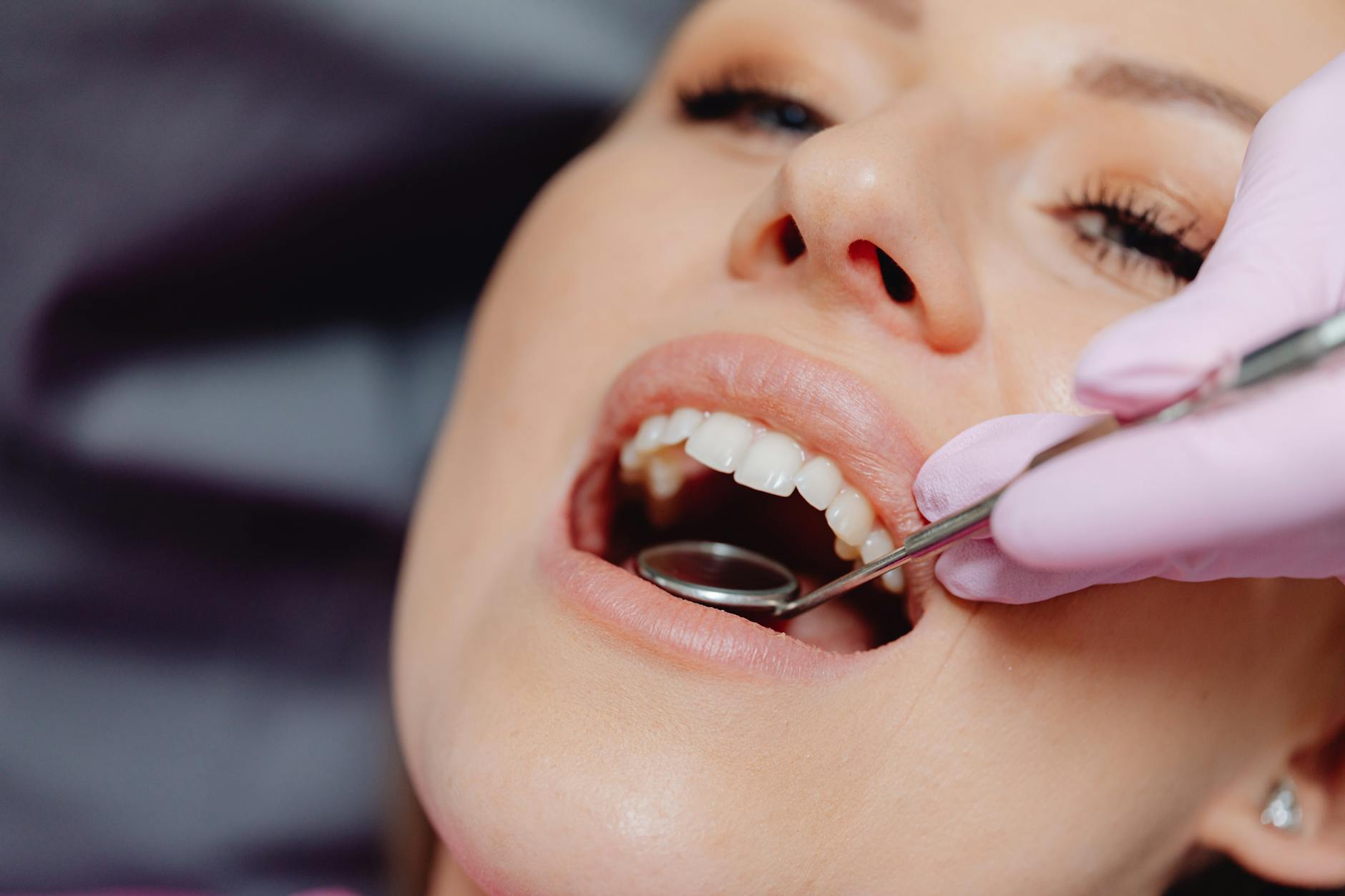 Close-up of a patient getting a dental checkup with dental tools in use. — Atrium Scientific Group