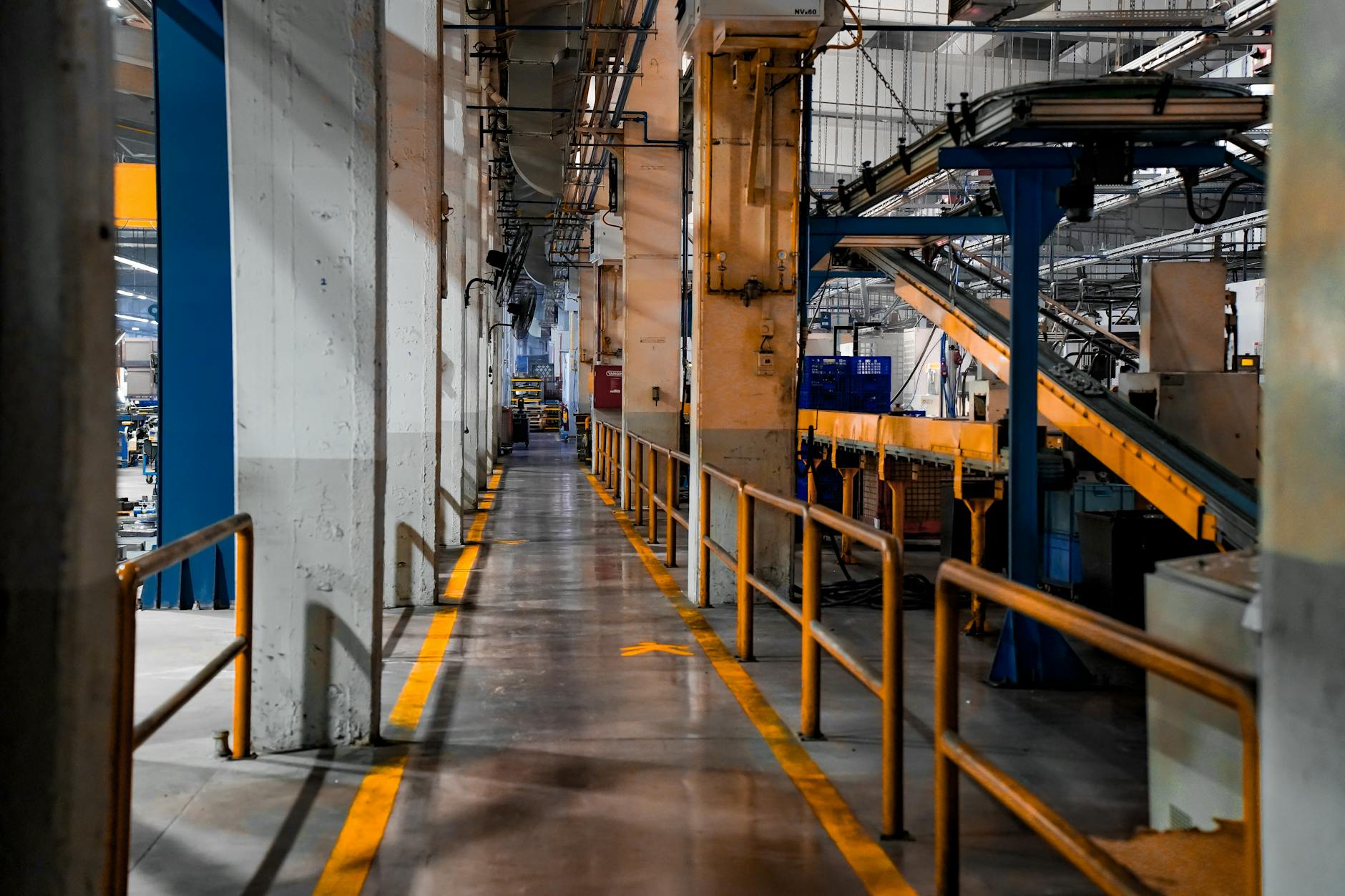 Wide view of a modern factory interior showcasing industrial machinery and conveyor systems. — Atrium Scientific Group