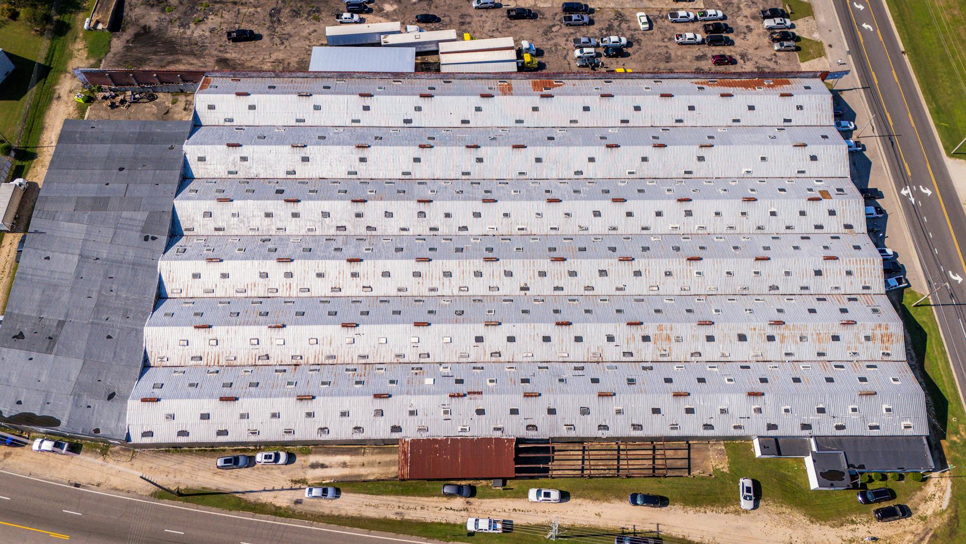 Aerial view of a large industrial warehouse with metal roofing in Wilson, North Carolina. — Atrium Scientific Group